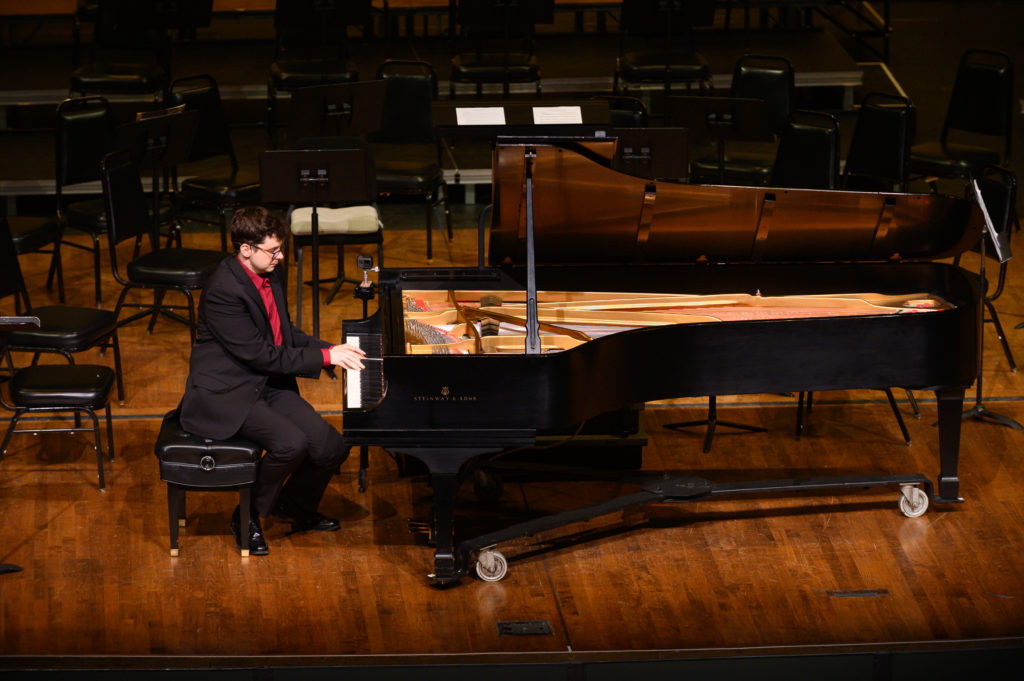 Dr. Geoffrey Pope demonstrates on the piano during his pre-concert lecture.